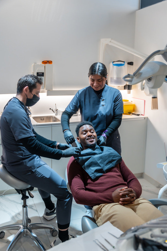 dentist-and-assistant-preparing-patient-for-dental-2025-04-08-16-31-21-utc (1)