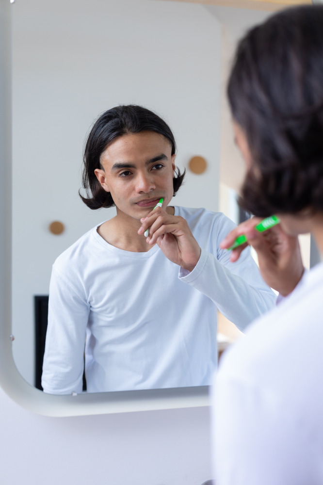 happy-biracial-man-brushing-teeth-in-bathroom-2025-04-03-13-09-37-utc (1)