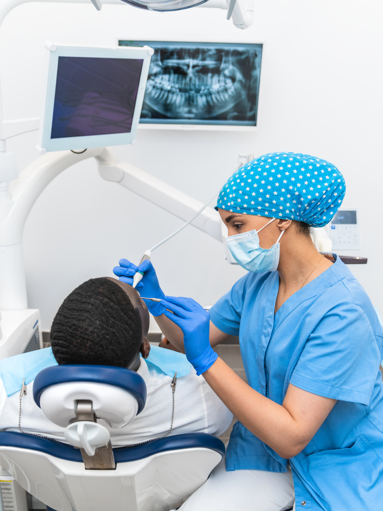 Dental hygienist conducting an oral examination using precision tools in a modern dental clinic.