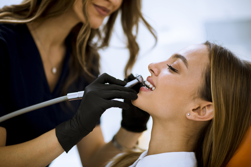 Close-up of female with open mouth during oral checkup at the de