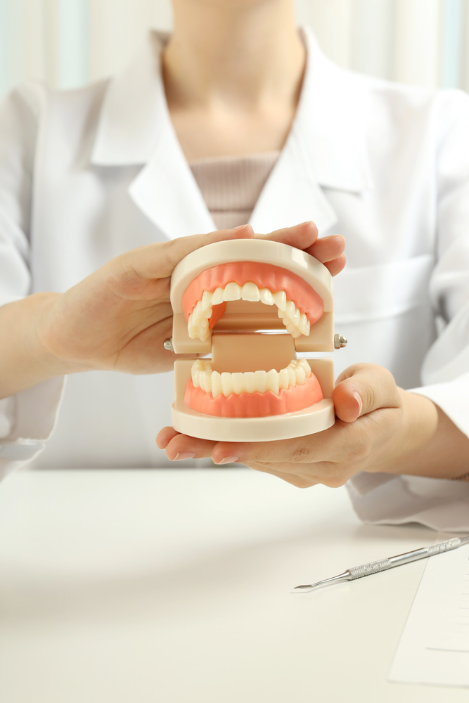 Concept of dental care or tooth care with female doctor