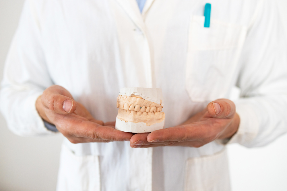 dental-technician-looking-at-plaster-cast-of-jaws-2025-03-12-23-44-58-utc (1)