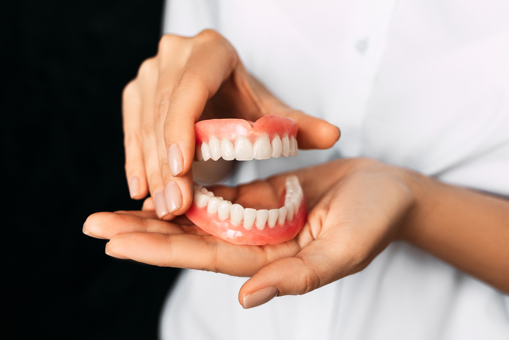 the-dentist-is-holding-dentures-in-his-hands-dent-2025-01-07-23-19-16-utc (1)