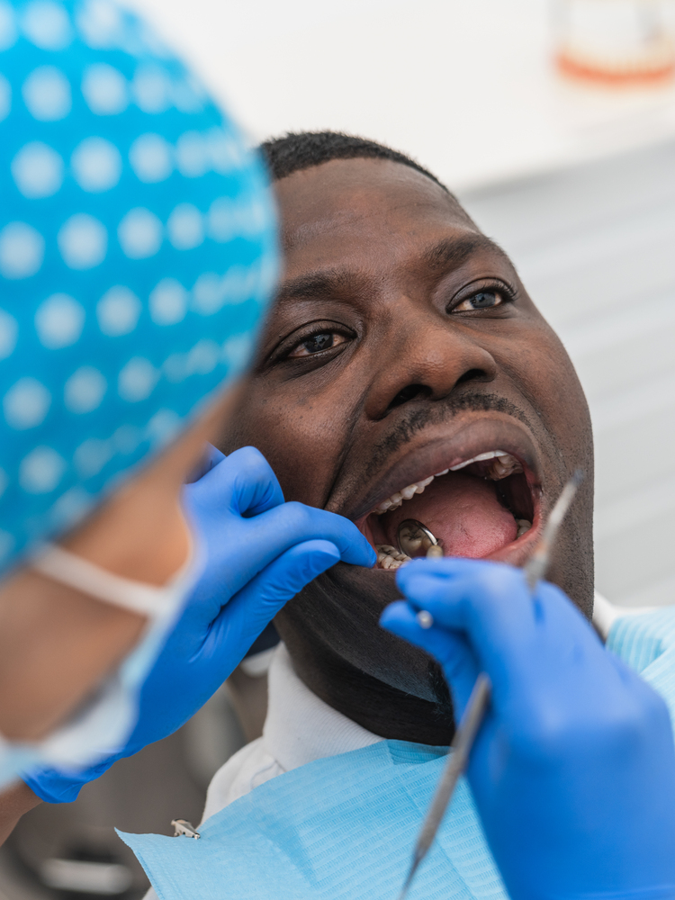 Close-up of dentist examining dental gums