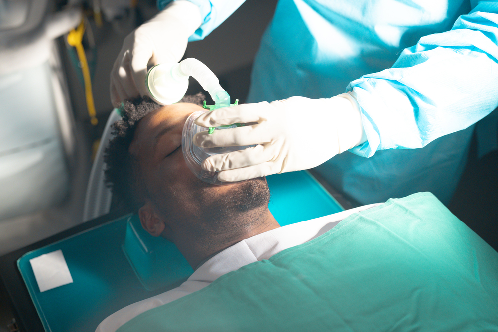 Dentist using nitrous oxide gas in patient