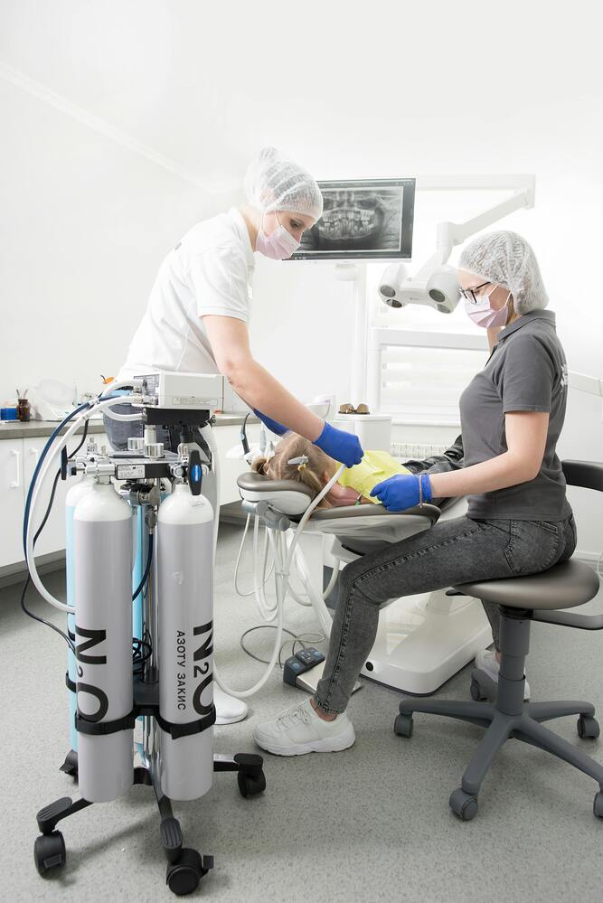 Dentists using N2O gas on patient