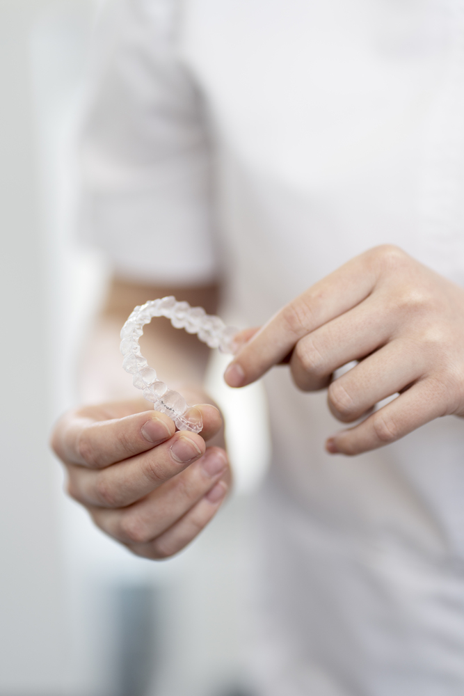 Closeup of doctor holding invisalign